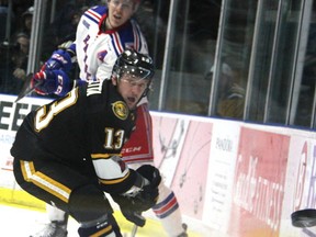 The Sting’s Michael Pezzetta tracks a clearing shot off the boards behind the Rangers net by Kitchener’s Logan Stanley during the first period of Game 4 of their OHL Western Conference semifinal at the Progressive Auto Sales Arena in Sarnia on Thursday night. The Rangers scored twice in the third period to win 5-3 and even the series 2-2. Game 5 is Friday night in Kitchener. (TYLER KULA, Sarnia Observer)