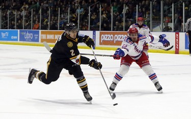 Sarnia Sting forward Theo Calvas, left, lets go a shot while the Sting were killing a penalty as Kitchener Rangers forward Adam Mascherin gives chase in Sarnia on Sunday during Game 6 of their Ontario Hockey League semifinal series. Greg Colgan/Postmedia Network