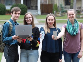 Central secondary school students, from left, Jon Roberts, Cassie Mathe, Chloe Martin and Amy Spence have outfitted their  electronic devices with anti-human trafficking stickers. The awareness campaign, using the hashtag #notonmyscreen, was launched by the International Justice Mission. (DALE CARRUTHERS / THE LONDON FREE PRESS)