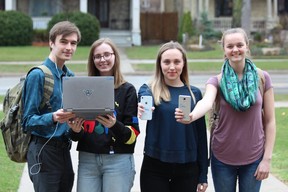 Central secondary school students, from left, Jon Roberts, Cassie Mathe, Chloe Martin and Amy Spence have outfitted their  electronic devices with anti-human trafficking stickers. The awareness campaign, using the hashtag #notonmyscreen, was launched by the International Justice Mission. (DALE CARRUTHERS / THE LONDON FREE PRESS)