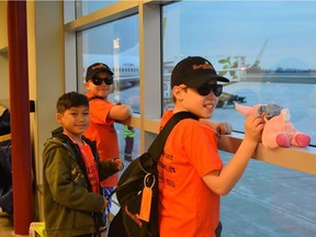 Sunshine Foundation kids Jake Hazelwood, left, 11, Ler Pway Moo, 11, and Jayce Galick, 9, are three of about 80 kids heading to Disney World for a whirlwind day-long trip Tuesday. (Jennifer Bieman/The London Free Press)