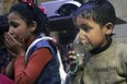 This image released early Sunday, April 8, by the Syrian Civil Defence White Helmets, shows a child receiving oxygen through respirators following an alleged poison gas attack in the rebel-held town of Douma, near Damascus, Syria. Syrian rescuers and medics said the attack on Douma killed at least 40 people. The Syrian government denied the allegations, which could not be independently verified. The alleged attack in Douma occurred Saturday night amid a resumed offensive by Syrian government forces after the collapse of a truce. (Syrian Civil Defense White Helmets via AP)