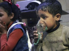 This image released early Sunday, April 8, by the Syrian Civil Defence White Helmets, shows a child receiving oxygen through respirators following an alleged poison gas attack in the rebel-held town of Douma, near Damascus, Syria. Syrian rescuers and medics said the attack on Douma killed at least 40 people. The Syrian government denied the allegations, which could not be independently verified. The alleged attack in Douma occurred Saturday night amid a resumed offensive by Syrian government forces after the collapse of a truce. (Syrian Civil Defense White Helmets via AP)