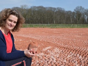 Lotte Moeyaert holds one of 600,000 clay figurines that fill the landscape in the former no man's land between allied and German trenches southeast of Ypres, in Belgium. The memorial figurines represent all the soldiers and civilians killed in Belgium during the First World War. The brainchild of Moeyaert's father, a teacher who's spent nine years working on the project, the figurines make up the ComingWorldRememberMe art installation on display until Nov. 11, the 100th anniversary of the armistice that ended the war. (Jennifer Bieman, The London Free Press)