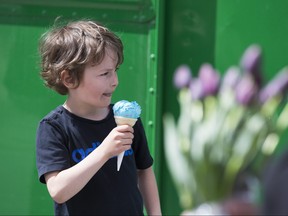 Jude Schock eats an ice cream cone during the first day for food truck at the Farmers Market in Saskatoon, SK on Saturday, May 5, 2018. (Saskatoon StarPhoenix/Kayle Neis)