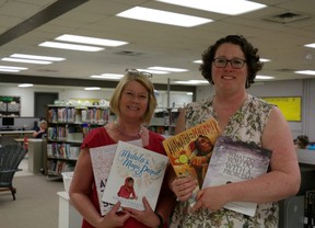 Lord Elgin elementary school principal Janice Davis, left, and librarian Sarah Iwasaki hold new library books courtesy of Indigo. The school ordered extra bookshelves to store the new books and resources. (SHANNON COULTER, The London Free Press)