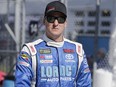 In this photo taken Feb. 19, 2017, D.J. Kennington walks on pit road before qualifying for the NASCAR Daytona 500 auto race at Daytona International Speedway in Daytona Beach, Fla.