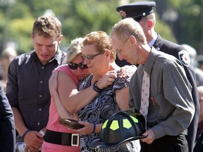 Relatives of late Point Edward firefighter Gary Kendall attend a memorial service for fallen firefighters in Ottawa in 2011, a year after Kendall died in a training accident. The family is calling for the province to regulate private firefighting training companies. (File photo)