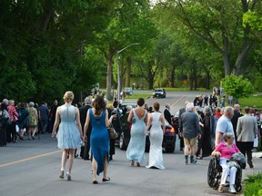 Stratford Festival patrons head toward the Avon River in their opening night finery after an "explosives threat" forced the evacuation of both the Festival and Avon theatres Monday. Galen Simmons/Postmedia Network