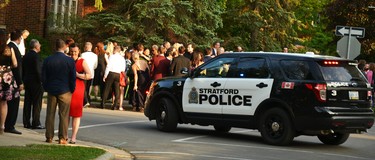 After reaching a safe distance, outside the police perimeter, Festival patrons, actors and staff gathered to watch events unfold. Galen Simmons/The Beacon Herald/Postmedia Network.