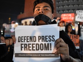 In this file photo taken on January 19, 2018, a protester displays a placard calling for press freedom in Manila.