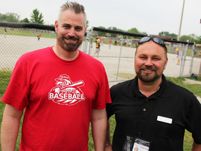 David Hogen, left, with the Sarnia Minor Athletic Association, and Sean Robbins, with Sarnia-Lambton Crime Stoppers, pose at a Germain Park baseball diamond Saturday. A recent $500 from a donated Crime Stoppers tip reward is going toward equipment purchases for young players, and for work on park diamonds. Tyler Kula/Sarnia Observer/Postmedia Network