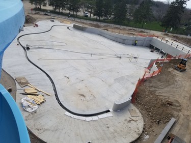 Construction on the mega-wave pool continues as a worker gets busy on one wall.