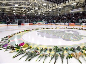 Flowers lie at centre ice as people gather for a vigil last month at the Elgar Petersen Arena, home of the Humboldt Broncos, to honour the victims of a fatal bus accident in Humboldt, Sask. Canadian Press file photo