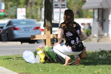 Mandi Billedeau placed a bouquet of flowers at a makeshift memorial for Dereck Szaflarski, 27, who was killed during a fight near Richmond and Piccadilly streets on Saturday, May 26, 2018. Billedaua and other friends visited the memorial on Monday to pay their respects to Szaflarski. DALE CARRUTHERS / THE LONDON FREE PRESS