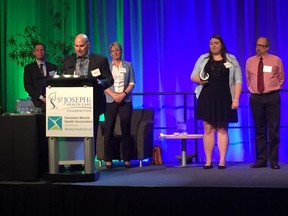 Lubrico Warranty staff accept the Champion of Mental Health Award at the Breakfast of Champions at the London Convention Centre Tuesday. The sold-out benefit supports mental health programs through the St. Joseph's Health Care Foundation. (JENNIFER BIEMAN, The London Free Press)