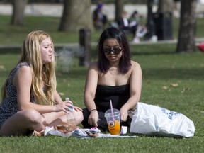 A young woman smokes a marijuana cigarette with a friend in Victoria Park during 420 Day on April 20, 2016. Western student YiMin Shen says Ontario’s plans for government-run marijuana sales outlets are doomed to fail. (Free Press files photo)