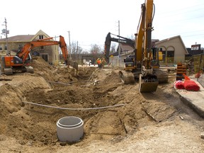 New sanitary and storm sewers and water service is tearing a big gap in York Street just west of Ridout in London. Three excavators are busy on the site that has snarled traffic heading west from the core. (MIKE HENSEN, The London Free Press)