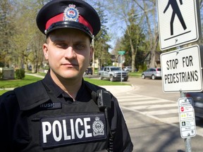 Const. Ben Hush and other London police traffic division officers were on a mission recently to remind drivers that pedestrians have the right of way at crossovers like this one on Colborne Street. Drivers must stop behind the stop line and wait for walkers to cross completely, or risk a $500 fine and three demerit points, police say. Pedestrians should be vigilant, make eye contact with drivers and not cross until traffic stops. (MIKE HENSEN, The London Free Press)