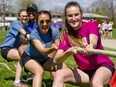 Danielle Lanooy of Central secondary school, front, is backed up by schoolmates Julianna Mereu, left, Rachel Almaw and Yen Duong in a tug of war at the OneRun event  hosted by Westminster secondary school Monday. With perfect weather, the event drew hundreds of students from Westminster, Central and some elementary schools including Byron Somerset, who forrmed teams of 10 people each to  run 100 km on the track to raise funds for cancer research. OneRun was started in 2010 with cancer survivor Theresa Carriere running from Sarnia to London to raise funds and awareness, and now 10 secondary school events continue the drive. Mike Hensen/The London Free Press