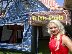 Elizabeth Morgan of One Eye Entertainment with their newest piece, a blow up pub in London. (MIKE HENSEN, The London Free Press)