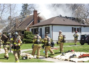 Firefighters responded to burning houses at 27 and 25 Glass Ave. on Tuesday in London. Witnesses said the fire started on the rear porch of 27 Glass Ave. and spread to 25 Glass Ave. No one was injured. (Derek Ruttan/The London Free Press)