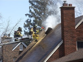 Firefighters responded to burning houses at 27 and 25 Glass Ave. on Tuesday in London. Witnesses said the fire started on the rear porch of 27 Glass Ave. and spread to 25 Glass Ave. No one was injured. (Derek Ruttan/The London Free Press)