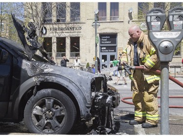 Firefighters were called to dowse a burning Ford Freestyle parked on Dundas Street in Old East Village on Tuesday. The driver of the vehicle was shopping in the area and returned to find the vehicle ablaze. No on was injured. The cause of the fire is unknown. (Derek Ruttan/The London Free Press)