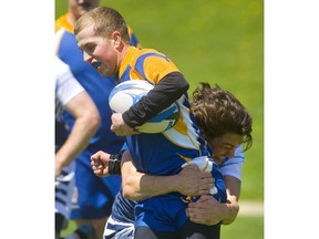 Tyler Arndt of the Lucas Vikings wraps up Beal Raiders' Carter Putt in a Thames Valley varsity boys rugby match Tuesday at Lucas. Lucas won 27-7.  (Mike Hensen/The London Free Press)