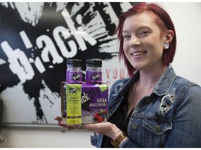Black Fly Beverage Company sales and marketing support administrator Charlotte Gooding displays their Mixed Berry Vodka coolers that come with a one-time-use breathalyzer. Derek Ruttan/The London Free Press