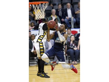 Antoine Mason of the Halifax Hurricanes sails past Doug Herring Jr. of the London Lightning on way to a lay up during Game 3 of their NBL of Canada championship series in London, Ont. on Thursday May 10, 2018. (Derek Ruttan/The London Free Press)