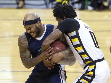 Tyrone Watson of the Halifax Hurricanes fights for the ball with Mo Bolden of the London Lightning during Game 3 of their NBL of Canada championship series in London, Ont. on Thursday May 10, 2018. (Derek Ruttan/The London Free Press)