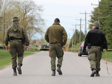 OPP officers closed off a section of Front Road Friday, about two kilometres north of Vanastra, where a body was found near the road on Thursday. (DALE CARRUTHERS / THE LONDON FREE PRESS)