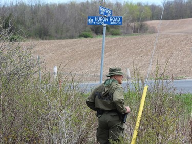 OPP officers closed off a section of Front Road Friday, about two kilometres north of Vanastra, where a body was found on Thursday. (DALE CARRUTHERS / THE LONDON FREE PRESS)