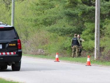 Investigators searched a wooded area off of Front Road , north of Vansatra, as part of a suspicious death investigation on Friday. DALE CARRUTHERS / THE LONDON FREE PRESS