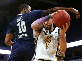 Julian Boyd of the London Lightning is fouled by Mike Poole of the Halifax Hurricanes in the first half of Game 4 of the National Basketball League of Canada best-of-seven final Saturday at at Budweiser Gardens. (Mike Hensen/The London Free Press)