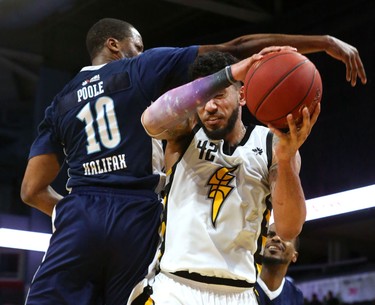 Julian Boyd of the London Lightning is fouled by Mike Poole of the Halifax Hurricanes in the first half of Game 4 of the National Basketball League of Canada best-of-seven final Saturday at at Budweiser Gardens. (Mike Hensen/The London Free Press)