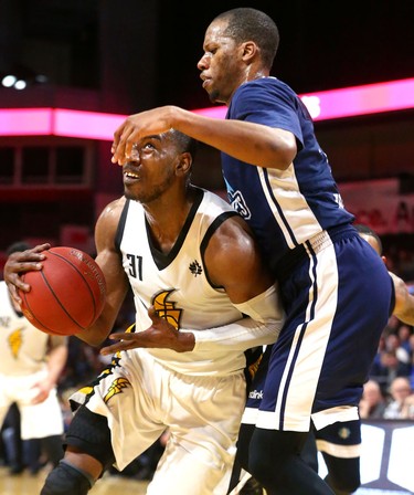 Kirk Williams Jr. of the Lightning gets fouled by Mike Poole of the Halifax Hurricanes during the first half of game four of the NBL finals at Budweiser Gardens in London, Ont. 
Photograph taken on Saturday May 12, 2018. 
Mike Hensen/The London Free Press/Postmedia Network