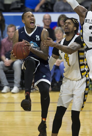 Billy White of the Halifax Hurricanes is fouled under the net by Mo Bolden of the London Lightning during their playoff game at Budweiser Gardens in London on Monday, May 14. Derek Ruttan/The London Free Press