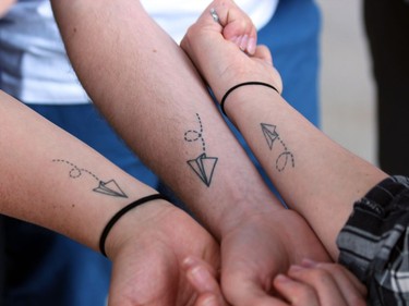 Family and friends of Nathan Deslippe show tattoos outside the London courthouse in memory of the London man who was killed on Aug. 28, 2016. William Joles was found guilty of the second-degree murder on Thursday.  (DALE CARRUTHERS / THE LONDON FREE PRESS)