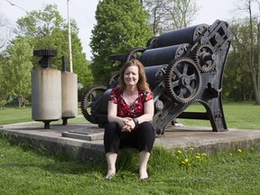 Western University history professor Michelle Hamilton sits beside a decommissioned soap milling machine in Richard B. Harrison Park in the SoHo area where  the London Soap and Cosmetics Company operated from 1875 to 1984. Stories of working-class London and others who often left out of history books will be featured in an audio tour of London historical sites now in the works. Derek Ruttan/The London Free Press