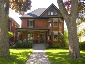 197 Elmwood with mature trees out front and geraniums on the porch for Geranium Walk Tour in London. (Mike Hensen/The London Free Press)