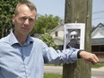 Lawyer Robert Talach stands near a poster at Dufferin Avenue and Quebec Street Thursday that features a photo of Lawrence Thompson and warns that he lives and worked in the neighbourhood. Talach did not post the poster. (DEREK RUTTAN, The London Free Press)