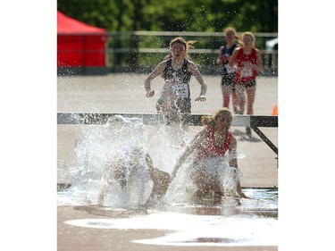 Elysse Fleming of London Central and Hazel Taylor of St. Mary's DCVI have some trouble with the water pit on the second lap of the girls 1500m steeplechase at TD stadium in London on Thursday, the first day of the WOSSAA track and field meet. Fleming went on to finish third behind OFSAA record holder Mikenna Vanderheyden. Mike Hensen/The London Free Press