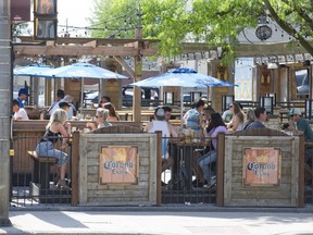 It was so hot that citizens huddled under sun umbrellas and consumed cold beverage at Barney's in London. (DEREK RUTTAN, The London Free Press)