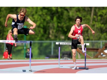 Nathan Hostetler of Medway, right, is the first over the hurdles at the start of the second heat of the senior boys 400m hurdles on Day 2 of WOSSAA at TD stadium on Friday May 25. Matthew McNeill of Lucas, left, was just behind him, on the first curve, but Hostetler kept his lead for the win. Mike Hensen/The London Free Press