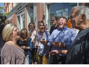 Andrea Horwath shares a laugh with former Liberal premier David Peterson, who cracked up onlookers, including Mayor Dan Mathieson, second right, by telling the surging NDP leader he knows the ups and downs of Ontario politics too well, having been 20 points down in the polls and winning -- and 20 points ahead and losing. The pair met as Horwath wrapped up a stop in Stratford in support of area candidate Michael O'Brien and Peterson, in town to see a Stratford Festival play, said hello after spotting Horwath's campaign bus. (DEREK RUTTAN, The London Free Press)