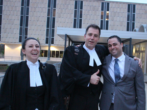 A relieved Const. Sean Coughlan, right, smiles with his legal team after a Sarnia jury delivered a not-guilty verdict Tuesday night. With him are lawyers Jennesa Plaine and Phillip Millar. NEIL BOWEN/Sarnia Observer