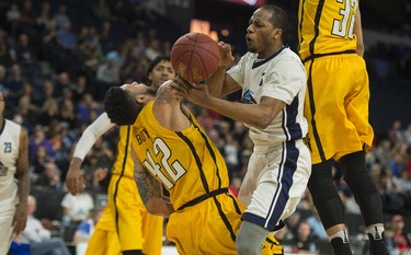 Halifax Hurricanes forward Mike Poole bowls over London Lightning forward Julian Boyd during the second half of Thursday night’s NBL Canada playoff game in Halifax. Boyd was called for a block on the play. The Hurricanes knocked off the Lightning 112-101 and will play Game 7 tomorrow night. 
(RYAN TAPLIN / The Chronicle Herald)