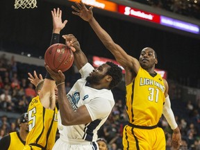 Halifax Hurricanes centre Rhamel Brown is fouled while being defended by London Lightning forward Garrett Williamson and Kirk Williams Jr. (31) during the second half of Thursday night’s NBL Canada playoff game in Halifax. The Hurricanes knocked off the Lightning 112-101 and will play Game 7 tomorrow night. 
(RYAN TAPLIN / The Chronicle Herald)